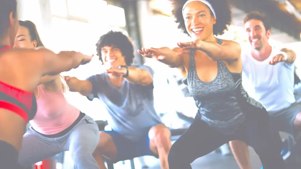 Group of healthy fit people at the gym exercising