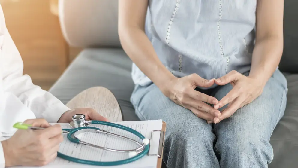 Woman sitting with doctor for consultation Woman sitting with doctor for consultation