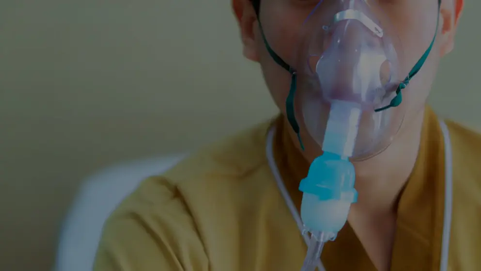 Young boy with cystic fibrosis, oxygen mask on his face