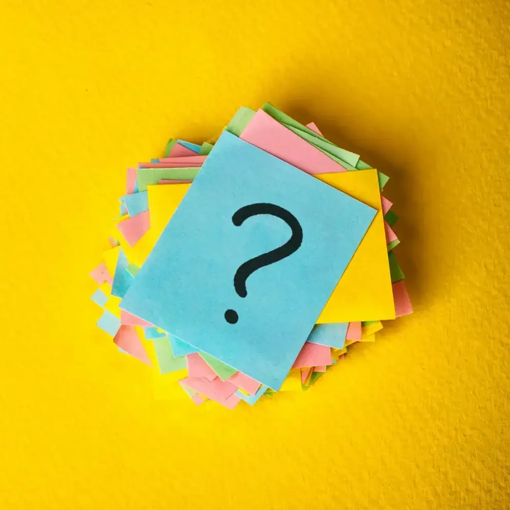 Collection of post-its on a yellow background with questions